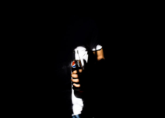shadowing commercial photo of a man holding a pepsi bottle 