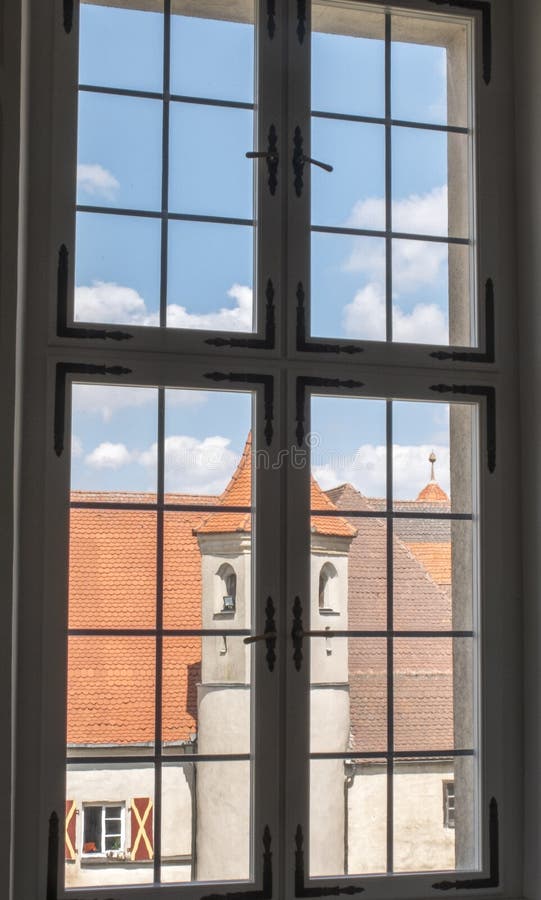 Ancient glass window with panoramic views. Over medieval buildings royalty free stock photos