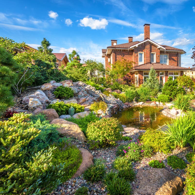 Andscape design of home garden. Beautiful landscaping with small pond. Landscaped place with rocks in summer. Moscow Region - Aug 24, 2019: Landscape design of stock photos