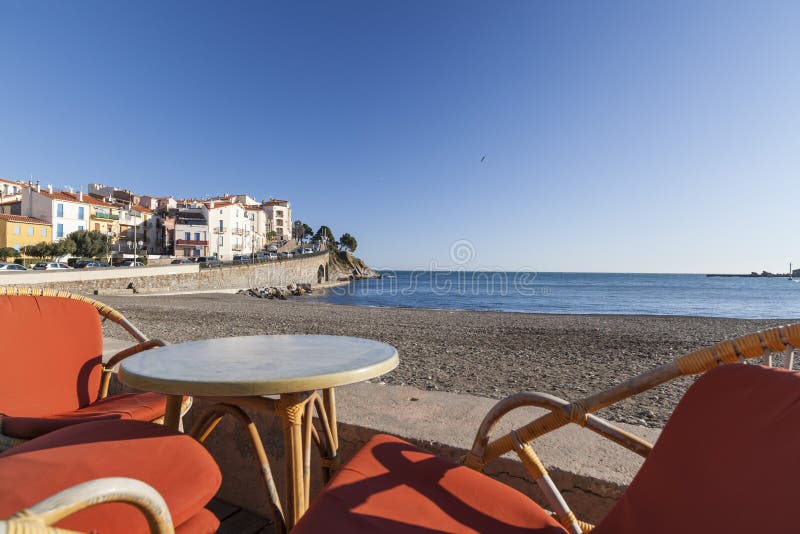 Beach and terrace bar view of maritime french village of Banyuls-sur-mer,Cote Vermeille,Occitanie,France. BANYULS-SUR-MER,FRANCE-JANUARY 24, 2012: Beach and royalty free stock images