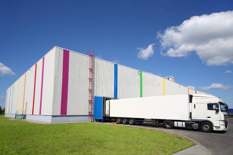 Big white truck is near warehouse of Caparol royalty free stock photo