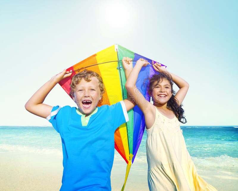 Children Playing Kite Happiness Cheerful Beach Summer Concept stock photos