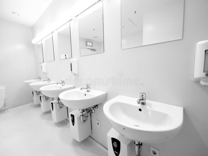 A clean new public toilet. Room empty stock photography