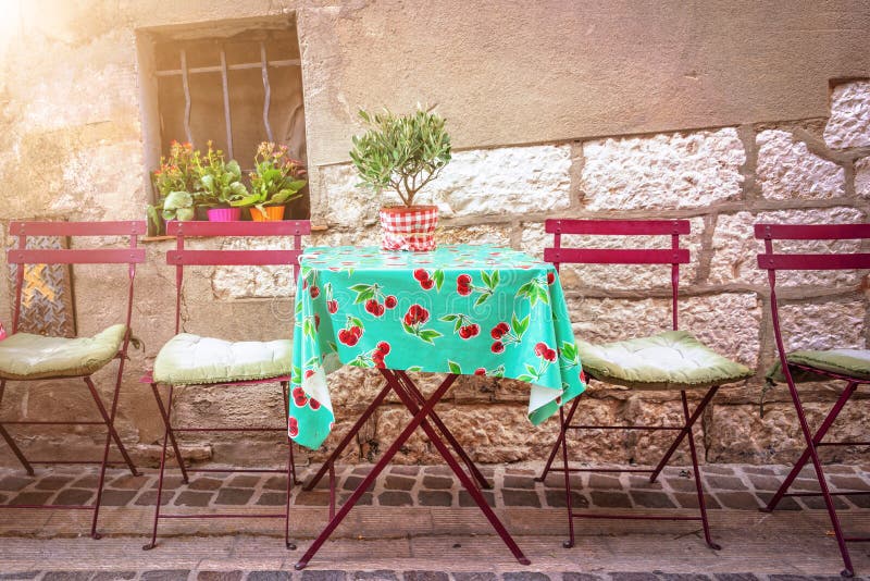Cosy vintage cafe terrace in a street of Cassis on the French rivieria France. Cosy vintage cafe terrace in a street of Cassis on the French rivieria, France royalty free stock photography