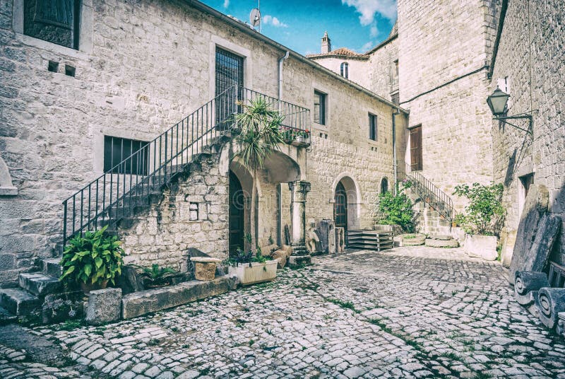 Courtyard of private house, Trogir, analog filter. Courtyard of private house in old town Trogir, Croatia. Architectural theme. Travel destination. Analog photo stock images