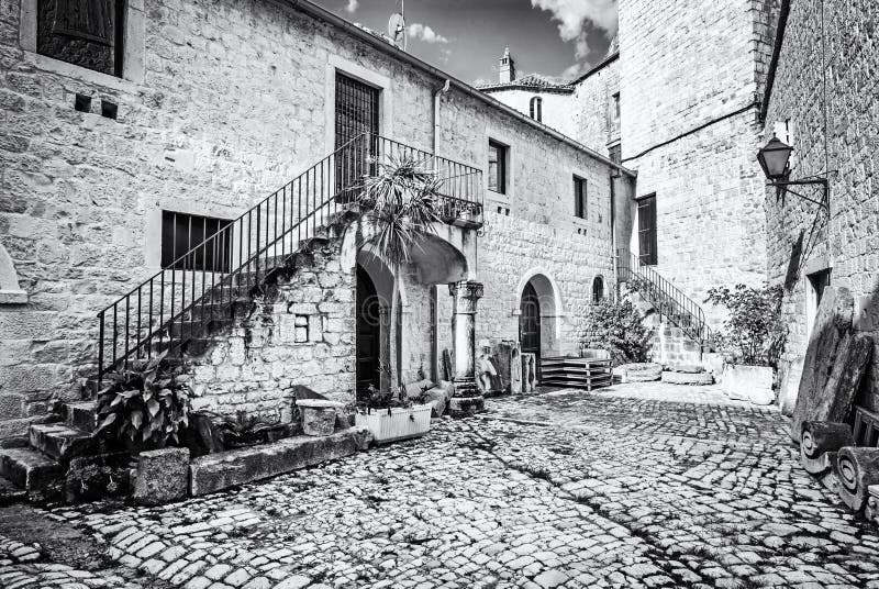 Courtyard of private house, Trogir, colorless. Courtyard of private house in old town Trogir, Croatia. Architectural theme. Travel destination. Back and white royalty free stock image