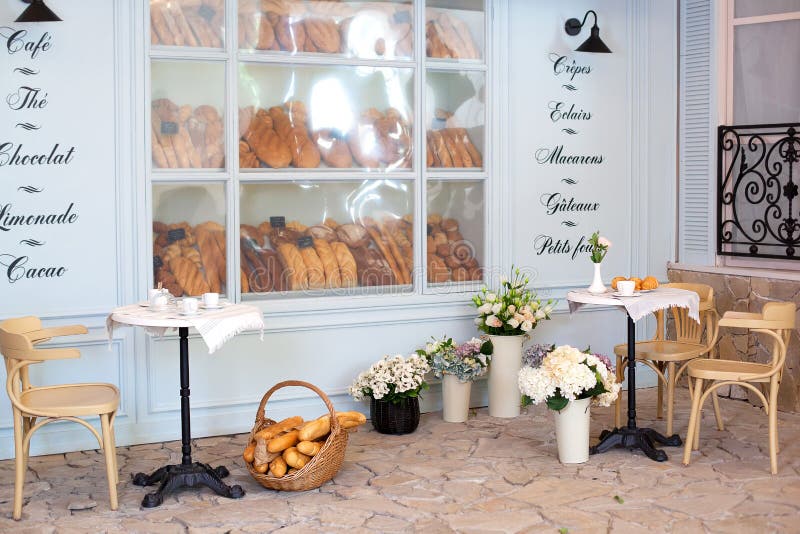 Empty coffee and restaurant terrace with tables and chairs in the French style. Freshly baked pastries, buns and bread in a bakery. Display case. Street cafe stock photos