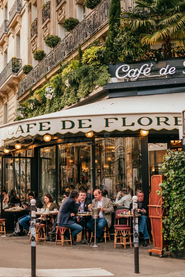 French cafe terrace. Paris, France - April 6, 2019: Charming traditional french cafe with tables on terrace, landmark in Paris royalty free stock image