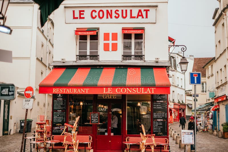 French cafe terrace. Paris, France - April 6, 2019: Charming traditional french cafe with tables on terrace in evening, landmark in Paris stock photos
