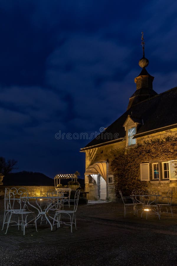 French looking and feeling terrace in Neercanne at the Dutch - Belgium border during blue hour. French looking and feeling terrace near the entrance of chateau royalty free stock photos