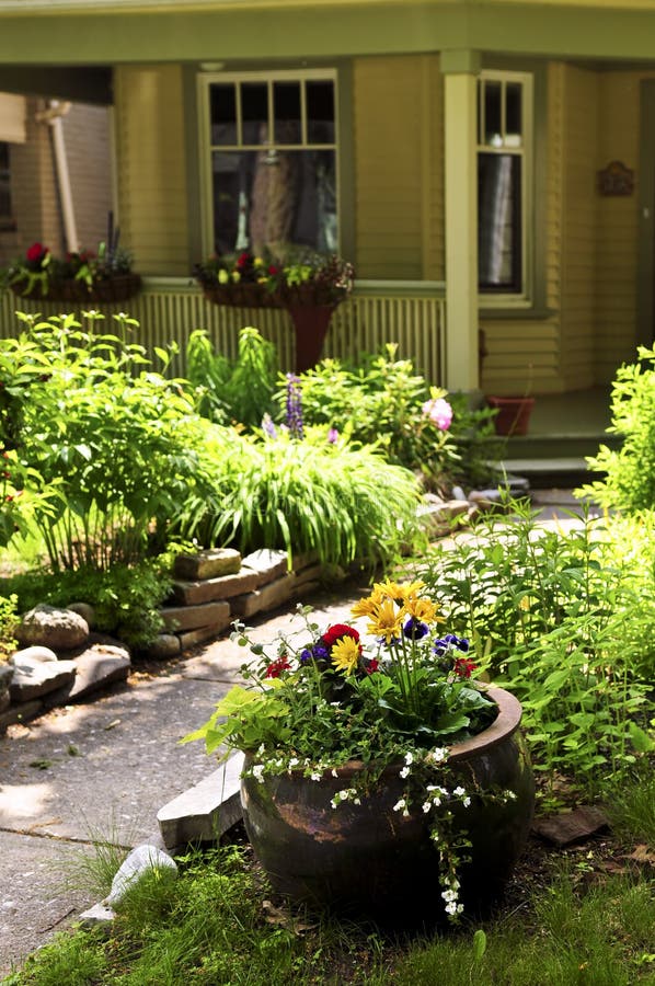 Front yard of a house. Landscaped front yard of a house with flowering garden and walkway stock photo