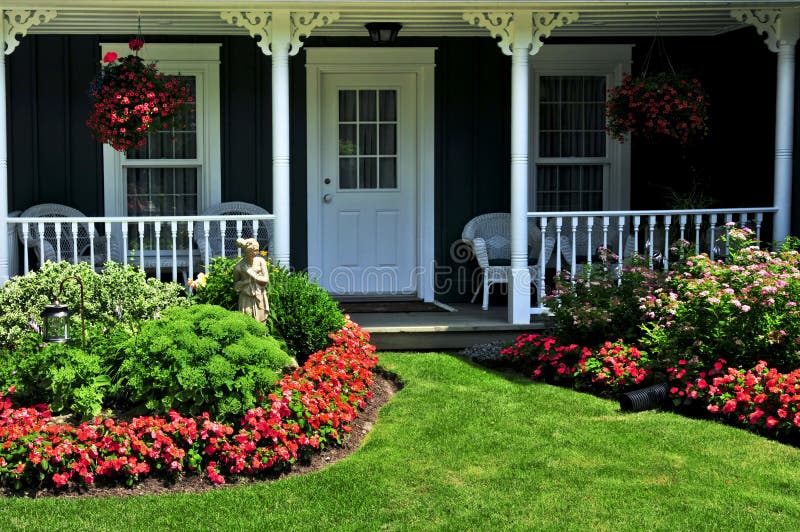 Front yard of a house. Landscaped front yard of a house with flowers and green lawn stock image