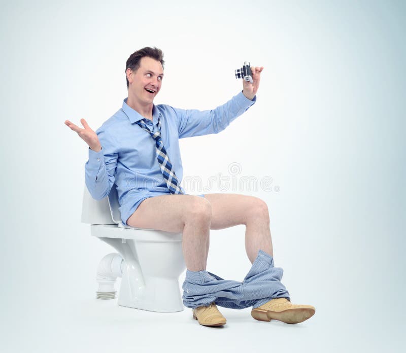 Funny man photographing himself in the toilet. Selfie concept.  royalty free stock image