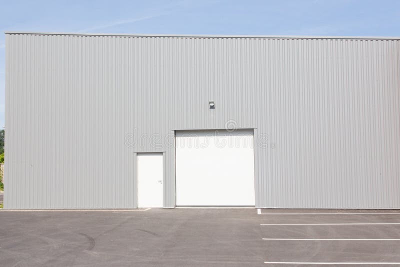 Warehouse building with blue sky and white door royalty free stock images