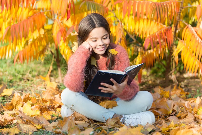 Hobby and interests. Child enjoy reading. Schoolgirl study. Study every day. Girl read book autumn day. Little child. Enjoy learning at backyard or park. Kid stock image