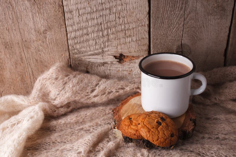 Warm knitted blanket, cup of hot tea and book on a wooden tray, autumn, winter seasonal background, cozy relax time in homely room royalty free stock images