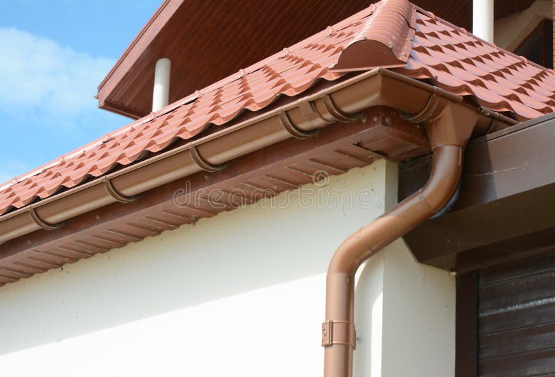 House attic metal roof with soffits, fascias, roof guttering, downspout gutter pipe. House metal roof with soffits, fascias, roof guttering, downspout gutter royalty free stock images