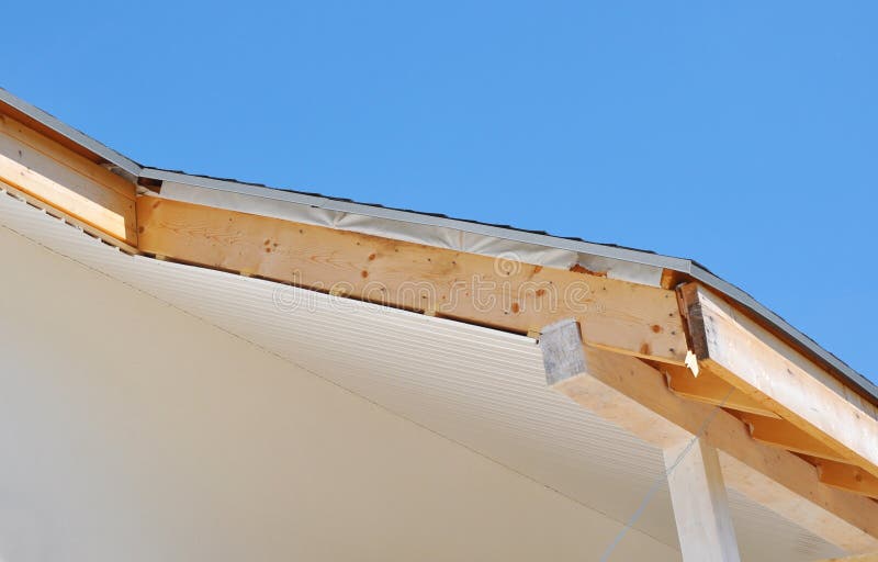 House roofing construction with installing soffits and fascia boards. Close up on house roofing construction with installing soffits and fascia boards. Roofing stock images
