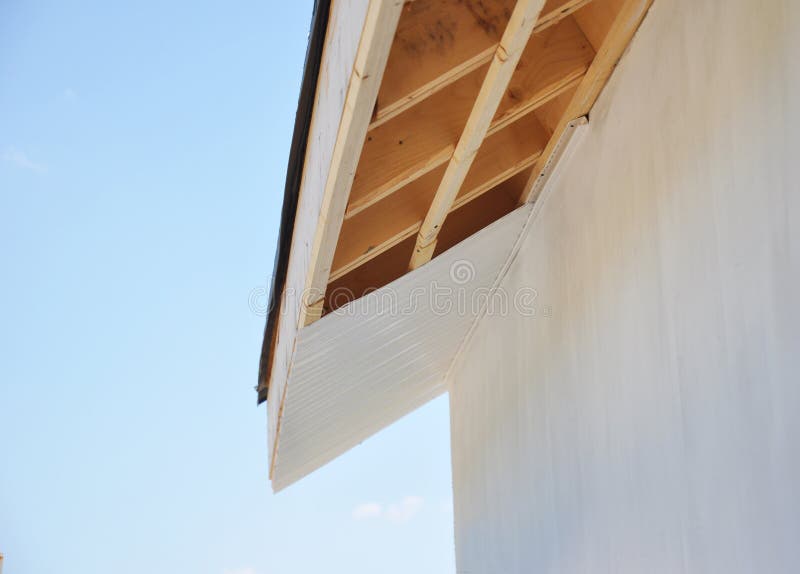 Installig eaves, soffit boards, fascias on new house roofing construction. Installig eaves, soffit boards, fascias on new home roofing construction royalty free stock images