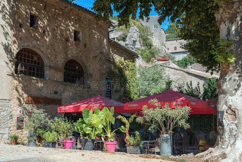 Restaurant with terrace under the platans in the picturesque village of Labeaume. Labeaume, France, September 7, 2016: Restaurant with terrace under the platans stock photos