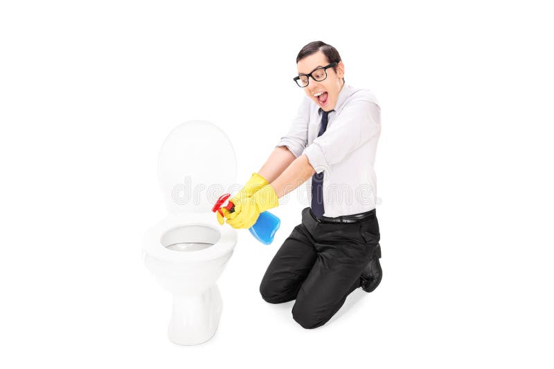 Man cleaning a toilet with disinfecting spray. Isolated on white background royalty free stock photo