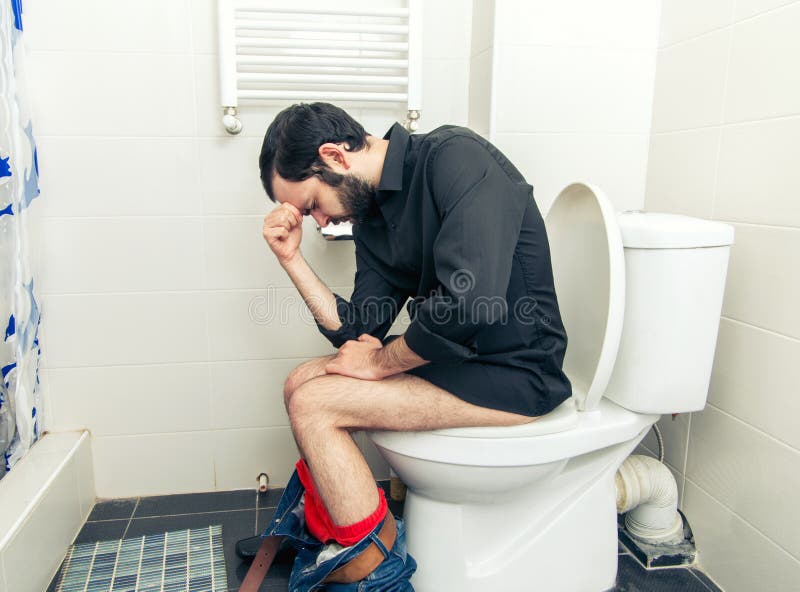Man having problems in toilet. Man having problems in the toilet royalty free stock image