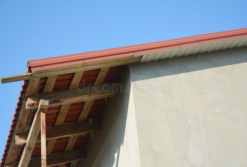 Metal roofing construction with unfinished eaves, fascia board. Soffits stock image