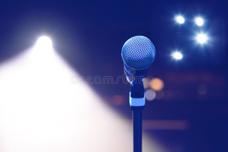 Microphone on the background of dark hall and soffits. Soft focus, selective focus.  royalty free stock images