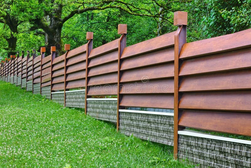 Modern Fence Made From Metal Siding Like As Natural Wood royalty free stock images