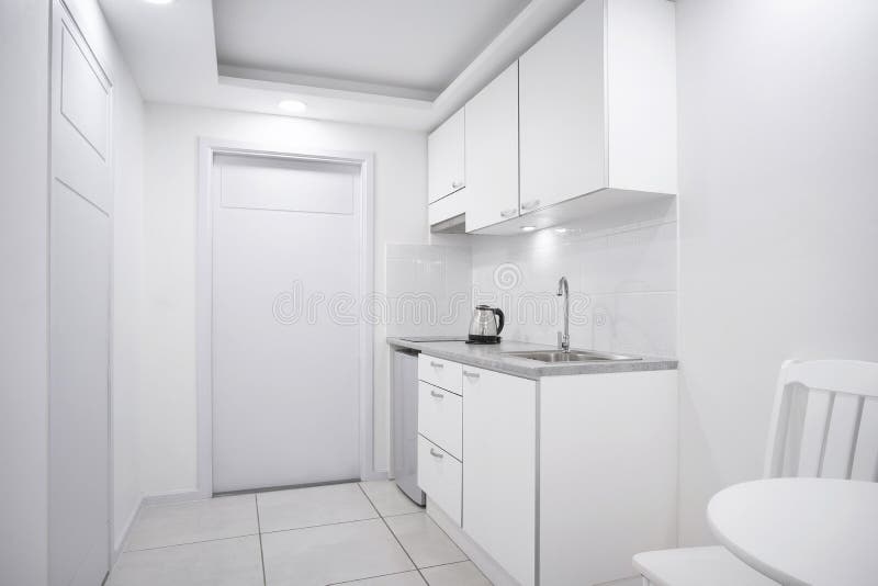 Modern interior white kitchen room with built-in furniture mockup showcase for boutique hotel room stock photos