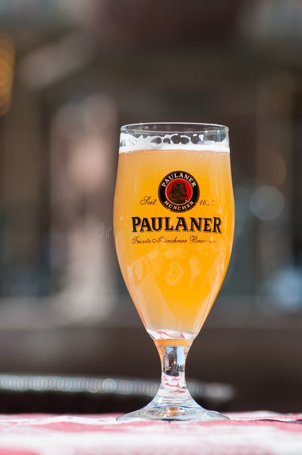 Closeup of glass of french beer from Paulaner` brand at restaurant terrace. Mulhouse - France - 23 May 2019 - Closeup of glass of french beer from Paulaner` royalty free stock photo