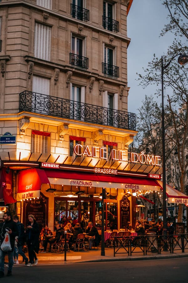 French cafe terrace. Paris, France - April 6, 2019: Charming traditional french cafe with tables on terrace in evening, landmark in Paris stock photos