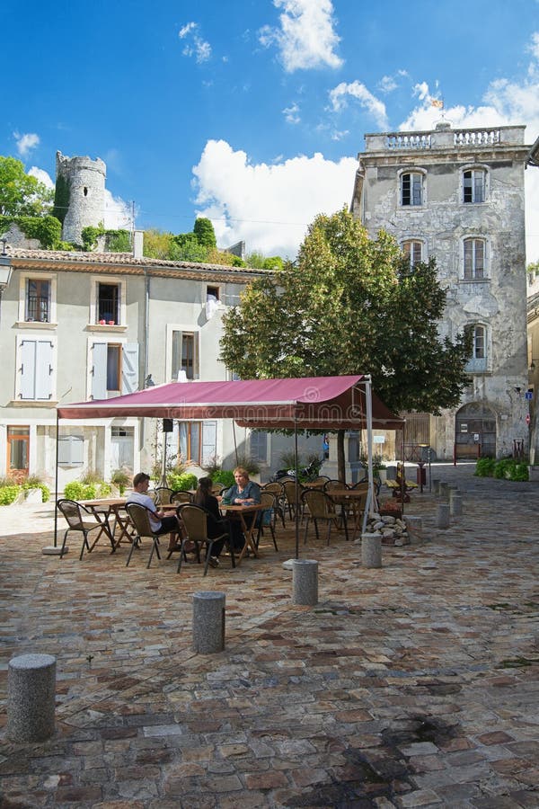 People sitting on a terrace on a square in the small village Saint Montan in the Ardeche region of France. Saint Montan, France, September 15, 2016: People royalty free stock photography