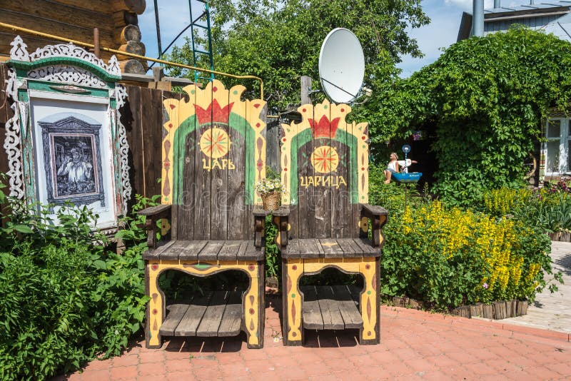 Two large wooden chairs in the courtyard of a private hotel 24.0. Ples city, Ivanovo region, Russia-24.06.2018: Two large wooden chairs in the courtyard of a stock images