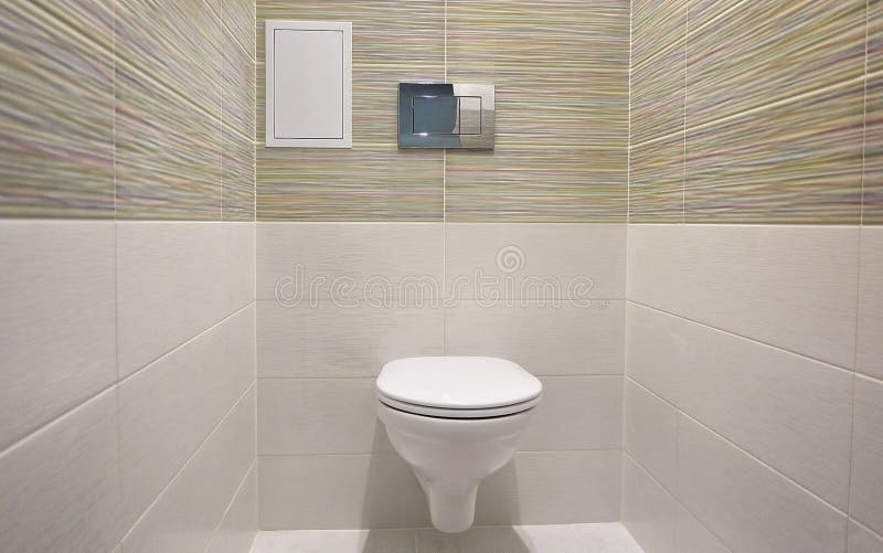Toilet design with built-in toilet. Built-in toilet is made as an installation, all the elements, except for the toilet are hidden. Behind the tiles in the wall stock photography