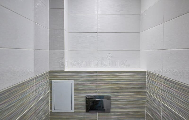 Toilet design with built-in toilet. Built-in toilet is made as an installation, all the elements, except for the toilet are hidden. Behind the tiles in the wall stock images