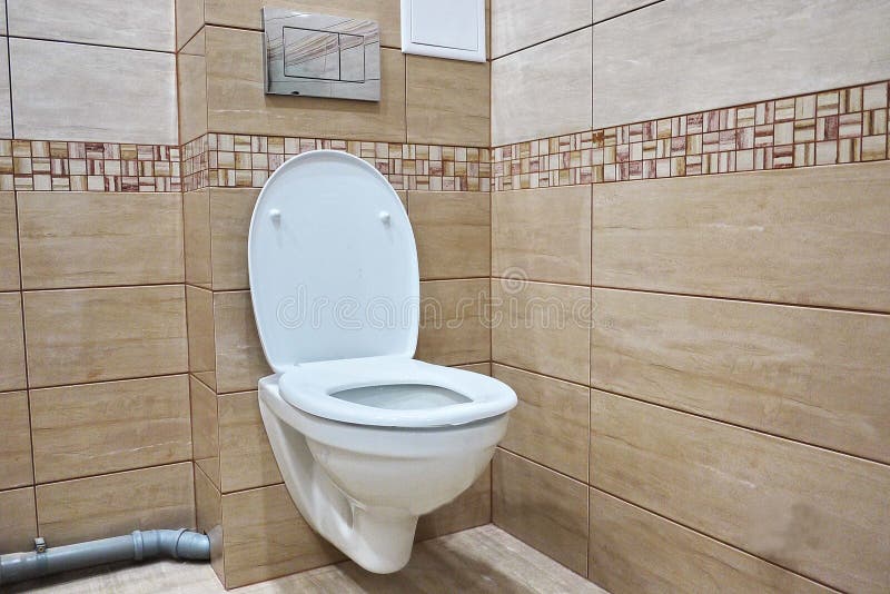 Toilet design with built-in toilet. Built-in toilet is made as an installation, all the elements, except for the toilet are hidden. Behind the tiles in the wall royalty free stock photos