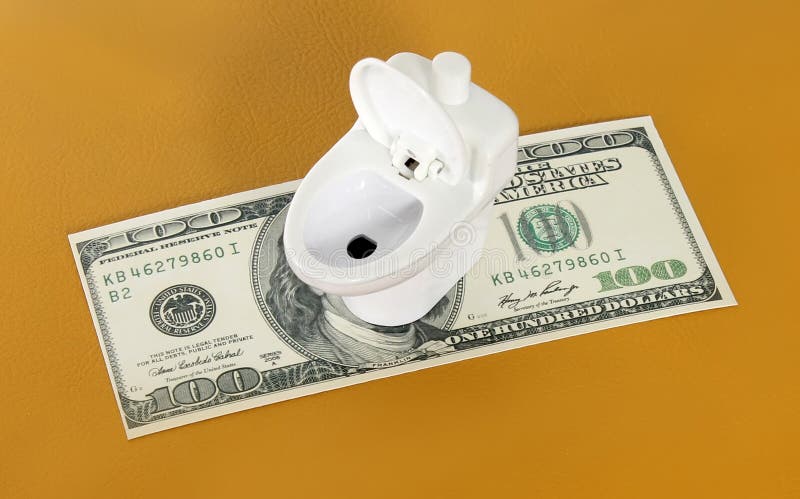Toilet for money. Toy toilet on the dollars stock images