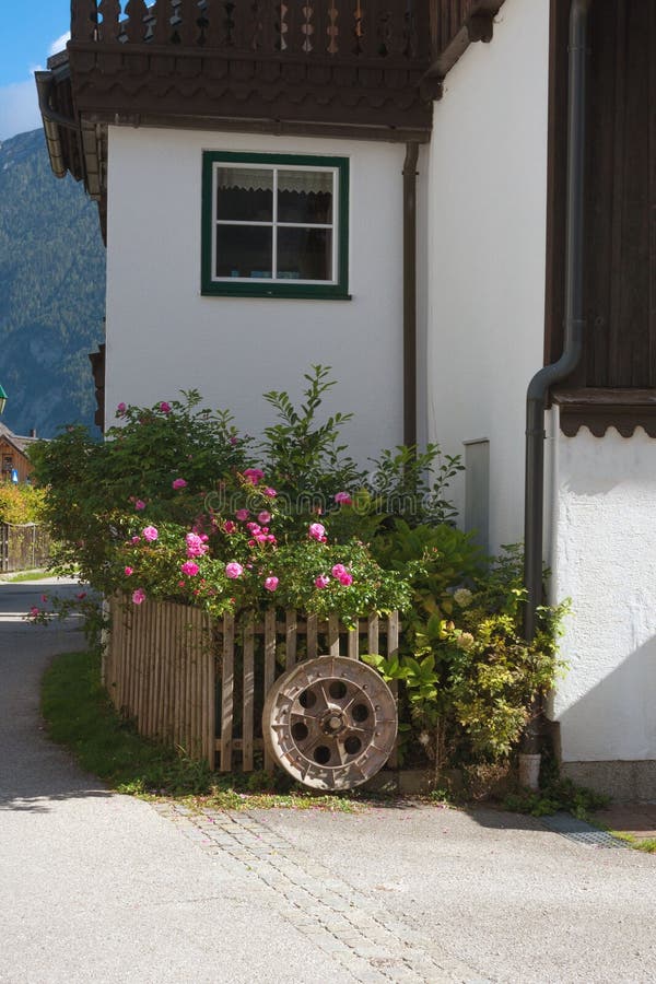 Traditional old Austrian house with flowers on a flower bed in the city of Hallstatt, Austria. Travel.  stock image