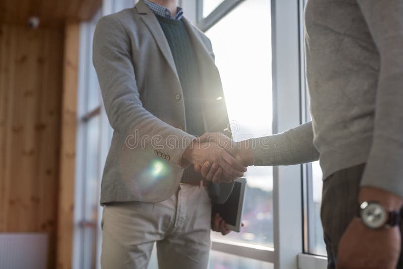 Two Business Man Shake Hand Agreement Coworking Center Business Team Coworkers Stand in front Big Panoramic Window. Modern Office stock photos