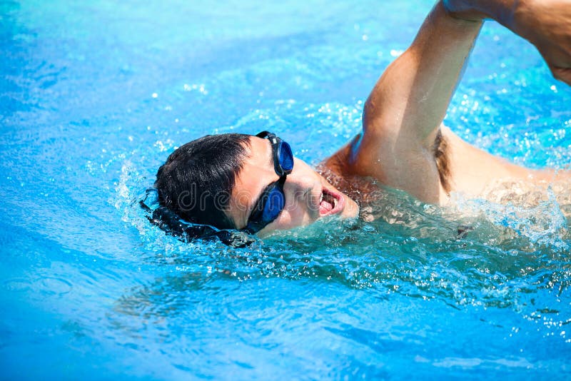 Young man swimming the front crawl royalty free stock images