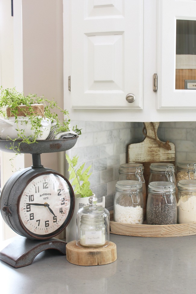 Farmhouse style clock scale in a white kitchen.