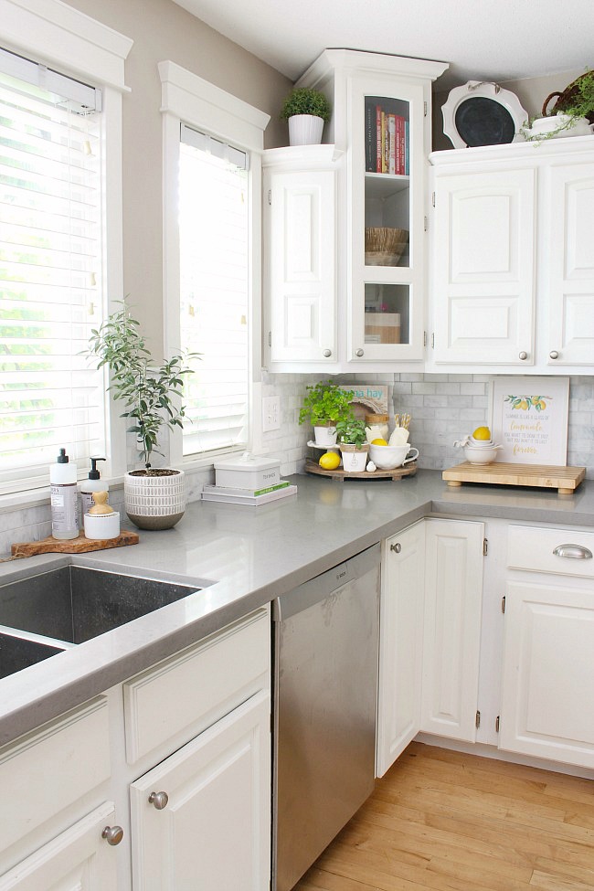 White farmhouse style kitchen decorated for summer with greens and yellow.